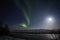 Active Aurora and Full Moon Light Over Cook Inlet