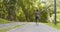 Active black runner jogging on special training path in public park