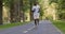 Active black runner training alone, running in empty city park