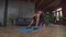 Active black woman exercising with push-ups bars