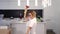Active blonde dances and sings holding red plunger