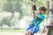 Active brave boy enjoying outbound climbing at adventure park on