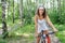Active brunette woman on red bicycle