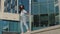 Active carefree cheerful happy young girl woman model winner walking on top on terrace of city building background