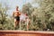 Active Caucasian athletes enjoying outdoor training in the park. They run with a parachute, showcasing their fit bodies