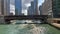 Active Chicago River during spring with kayaks, water taxi, and tour boats