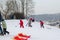 Active children fun in winter on hill with sledge