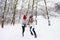 Active couple of teenagers making snowman