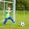 Active cute little kid boy playing soccer