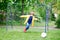 Active cute little kid boy playing soccer and football and having fun