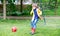 Active cute little kid boy playing soccer and football and having fun