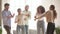 Active diverse cheerful friends dancing in living room