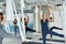 Active diverse women have stretching class on hammocks