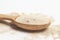 Active dry baking yeast granules in wooden spoon