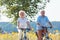 Active elderly couple riding bicycles together in the countrysid
