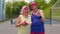 Active elderly man, woman after sport weightlifting dumbbells exercises, smiling looking at camera