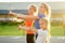 Active family at outdoor. two blonde woman twin sisters and their daughters in stylish sportswear warm up and do