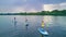 Active family on SUPs, standing up paddleboards, in river water, summer family sport, aerial top view