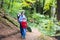 Active father with kids hiking in cliff and forest