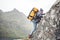 Active fearless professional tourist swarm up on mountains