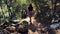 Active female tourist walking up on mountain forest trail in canyon. Girl traveller maintaining active healthy lifestyle, hiking a