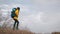 Active female tourist wearing leather hiking boots reaches the summit at stunning sunrise. Girl in casual shoes, walking