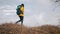 Active female tourist wearing leather hiking boots reaches the summit at stunning sunrise. Girl in casual shoes, walking