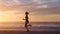 Active, fit and motivated woman running in slow motion on a beach at sunset outside. Silhouette of a determined and