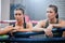 Active, fit and tired boxing female athletes and friends breathing, resting and taking a break after routine workout at