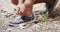 Active fit woman tying shoe in the park