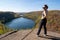 Active fit woman wearing athleisure clothing poses at the top of Bean and Bear Lake along the Superior Hiking Trail in fall