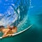 Active girl in bikini in dive action on surf board