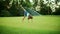 Active girl running in field. Cute kid doing cartwheel in meadow