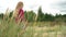 Active girl walking on sand dunes between tall grass near sea. 5 years old child