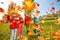 Active group of children play with flying leaves