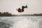 active guy jumps and makes flip over the water on wakeboard