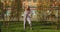 Active happy teen girl dancing, having fun on lawn outdoors on city street background. Cool playful child perform dance
