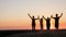 Active healthy family, grandmother with daughter and grandchildren meet the dawn, raise their arms above