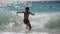 active healthy little boy with diving mask playing with stom sea ocean waves during summer vacation leisure activity in