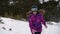 Active healthy little girl in winter sport ski suit and goggles running in deep snow during travel christmas vacation