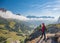 Active hiker hiking, enjoying the view, looking at Dolomites mountains landscape