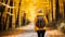 Active hiker woman enjoying scenic forest hike on a vibrant autumn trail in the fall season