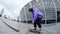 Active hipster trying trick on longboard. Focused guy falling from skate.