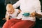 Active and inquisitive child six-month-old baby, mom sits nearby and holds a coffee mug