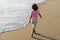 Active kid having fun on summer vacation. Child boy running on sand beach.