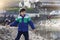 Active kid showing stone in his hand from the beach sand with bright light on spring or summer, little boy playing with the rock,