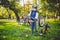 Active leisure for children in the park. A child is studying the mechanism of a mountain bike. Toddler fixing a bike in the forest