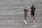 Active Lifestyle. Black Jogger Couple Running Down On Urban Stairs, Training Outdoors