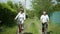 Active lifestyle, cheerful old couple grandmother and grandfather have fun together on bicycle during family bike ride