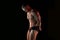 Active lifestyle concept. Professional bodybuilder showing perfect muscular body, lamps illumination on background